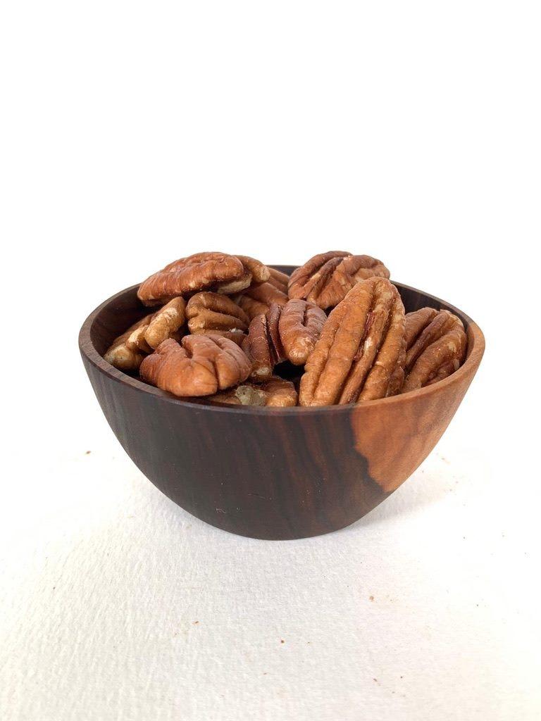 Organic pecans in a wooden bowl